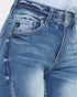 Close-up of blue jeans with brand logo on pocket area