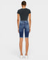Person wearing blue denim shorts and a black t-shirt on a white background