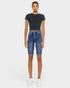 Person wearing a black t-shirt and blue denim shorts on a white background