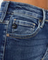 Close-up of blue jeans with a brand logo on the pocket.