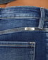 Close-up of blue jeans with a brand label on the waistband.