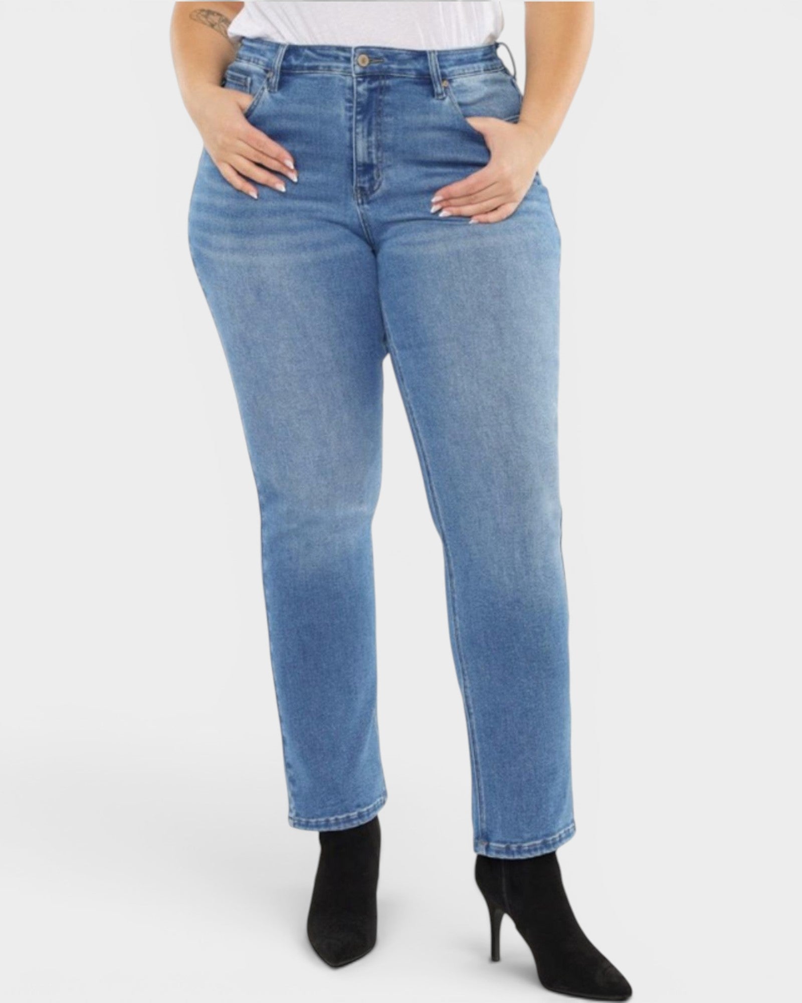 Person wearing blue jeans on a white background