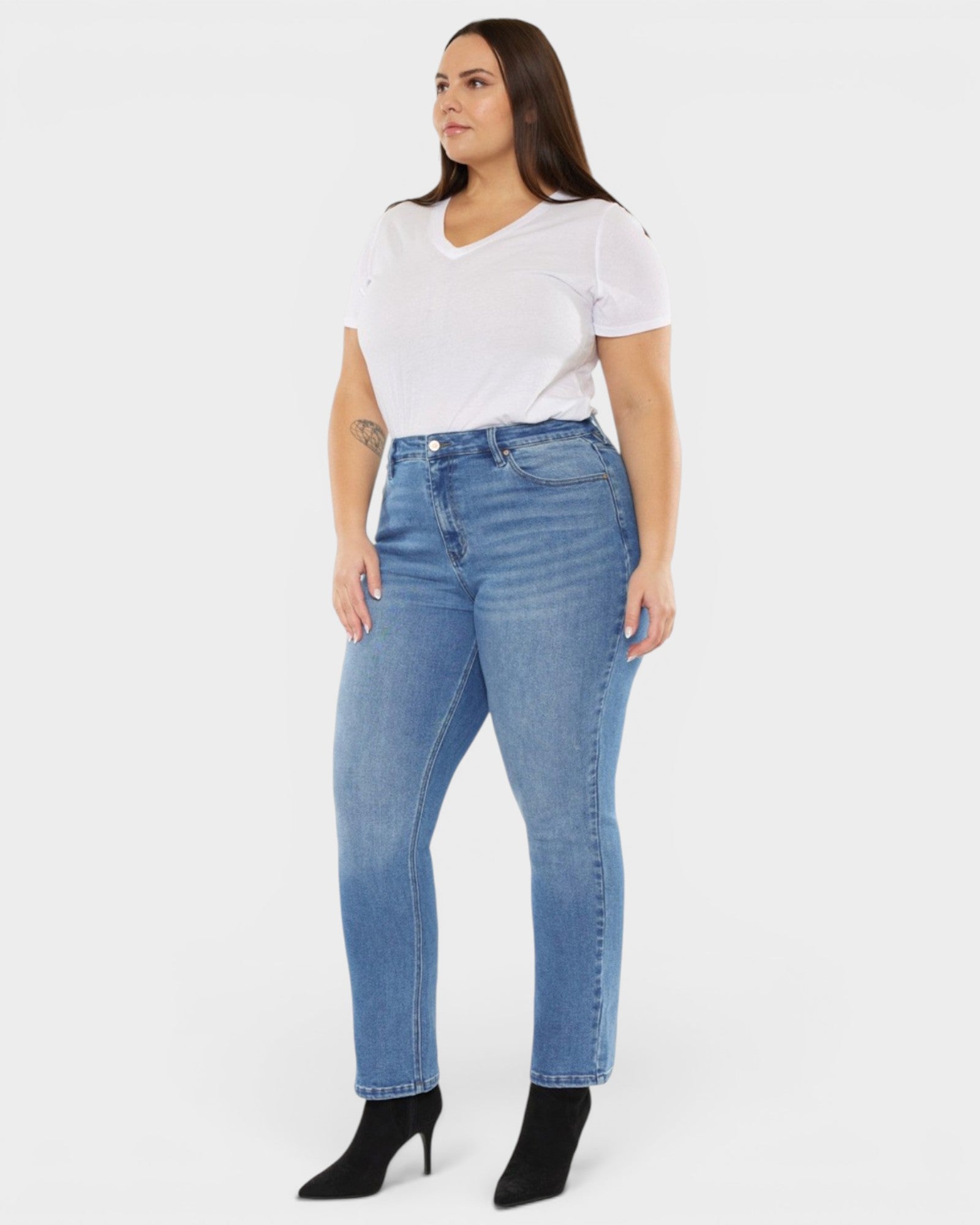 Woman wearing blue jeans and a white t-shirt on a white background