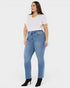 Woman wearing blue jeans and a white t-shirt on a white background