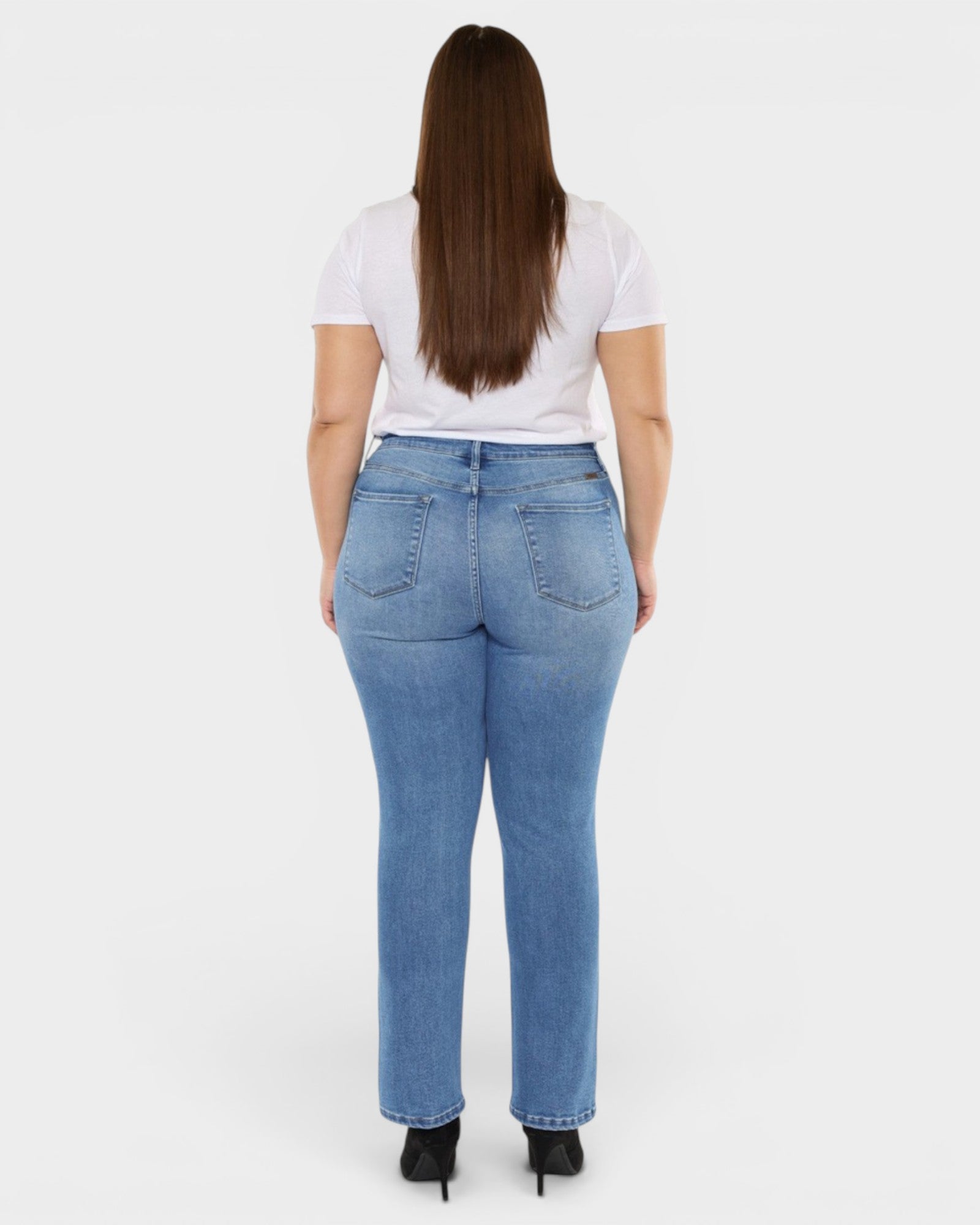 Person wearing blue jeans and a white shirt on a white background