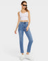 Woman wearing a white tank top and blue jeans on a white background