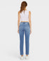 Woman wearing blue jeans and a white top on a white background