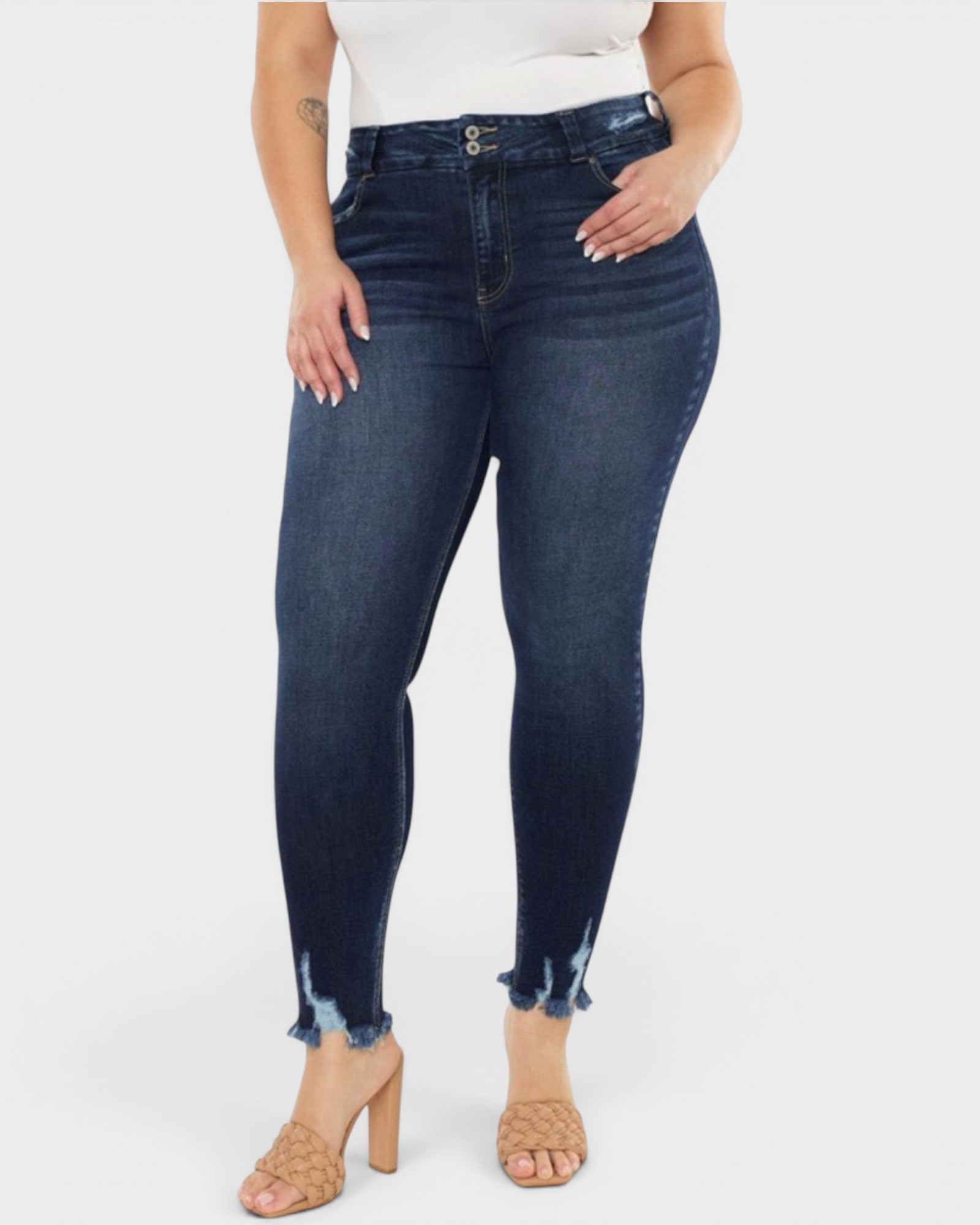 Person wearing dark blue jeans on a white background
