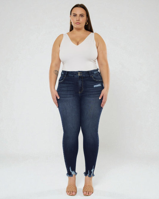 Woman wearing dark blue jeans and a white top on a white background
