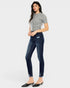 Woman wearing a gray top and blue jeans on a white background