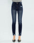 Dark blue jeans worn by a person on a white background