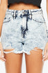 Denim shorts with a distressed look worn by a person on a white background