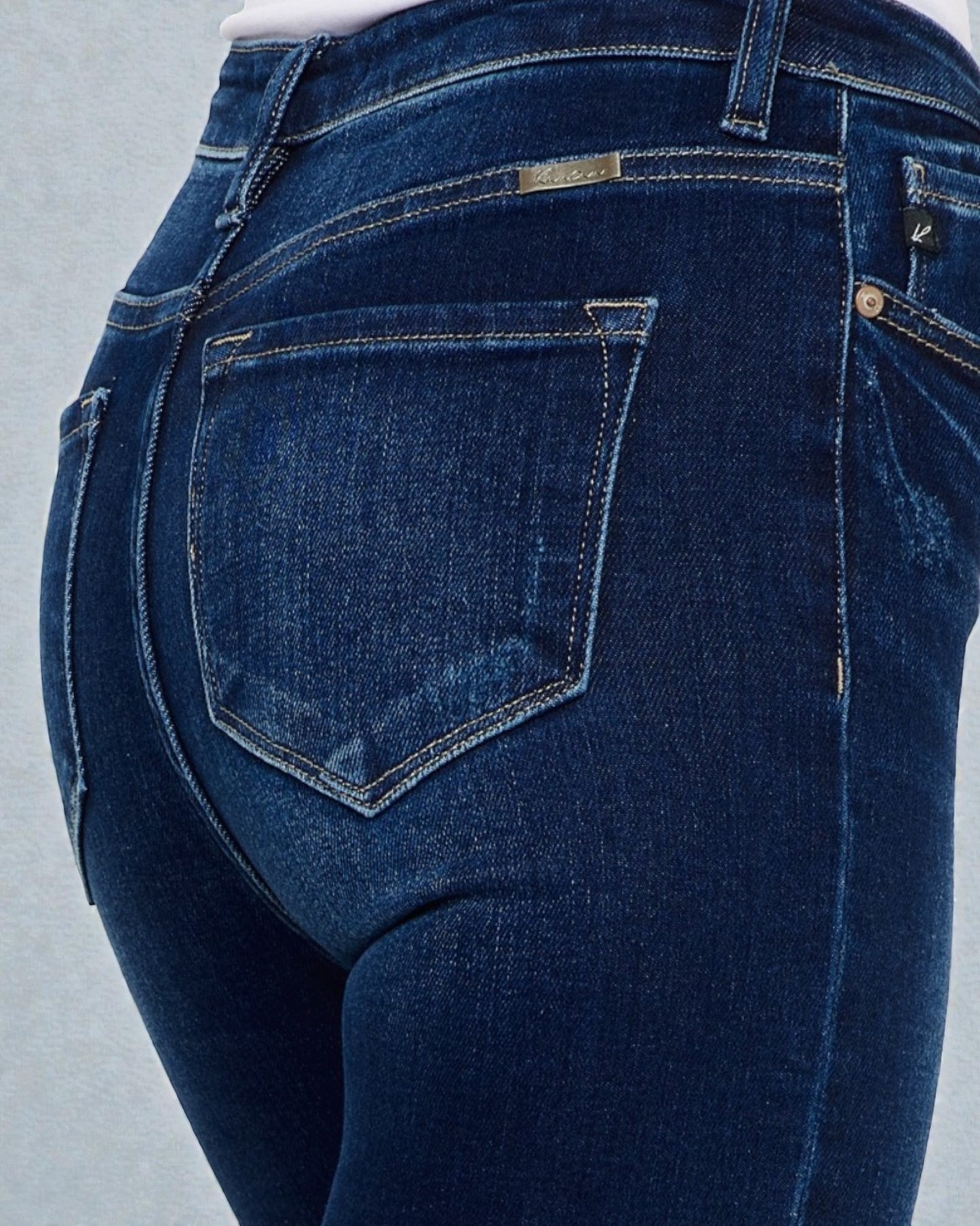 Close-up of blue jeans on a light gray background
