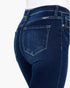 Close-up back view of dark blue denim jeans on a model, showing the back pockets, belt loops, and waistband against a plain white background.