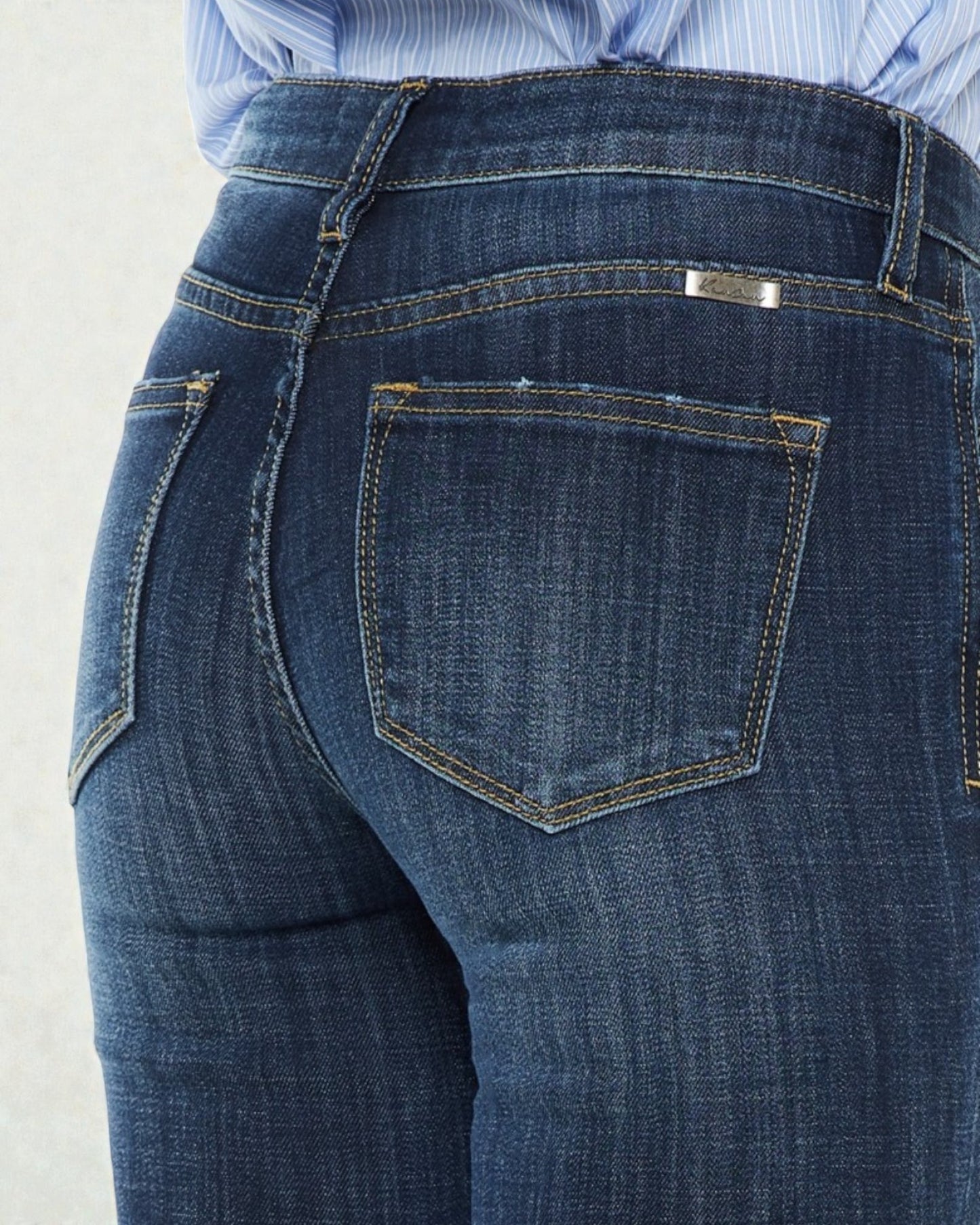 Close-up of blue jeans with a light gray background