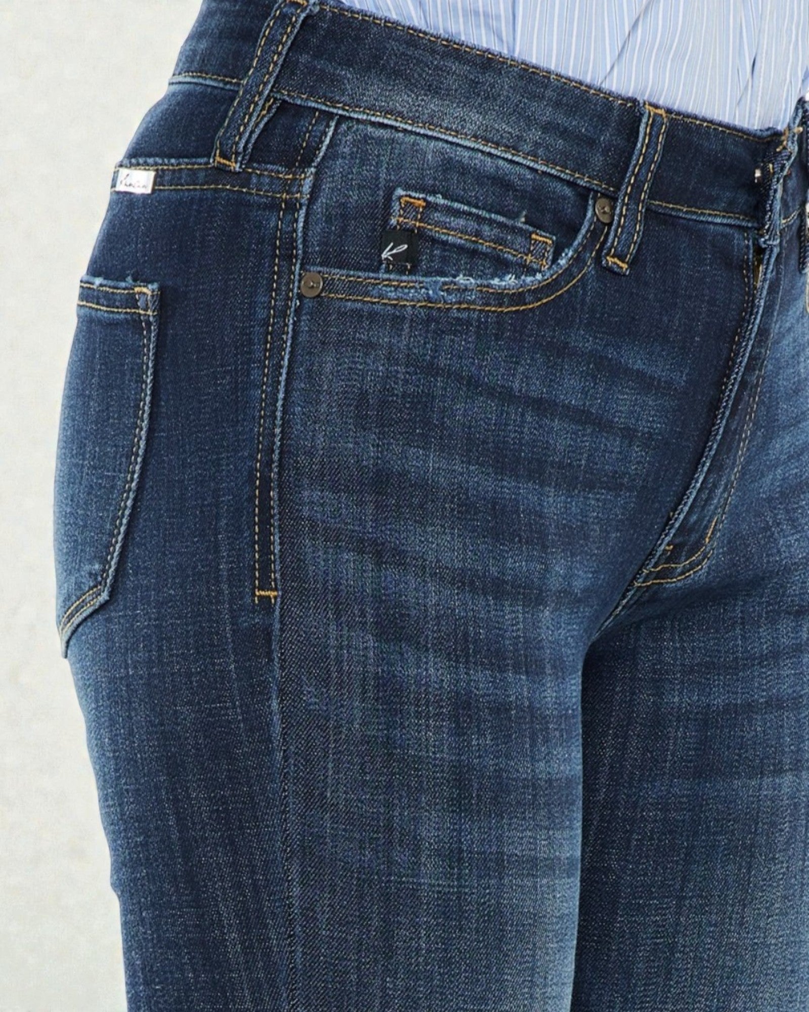 Close-up of blue jeans with a light gray background