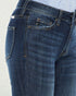 Close-up of blue jeans with a light gray background