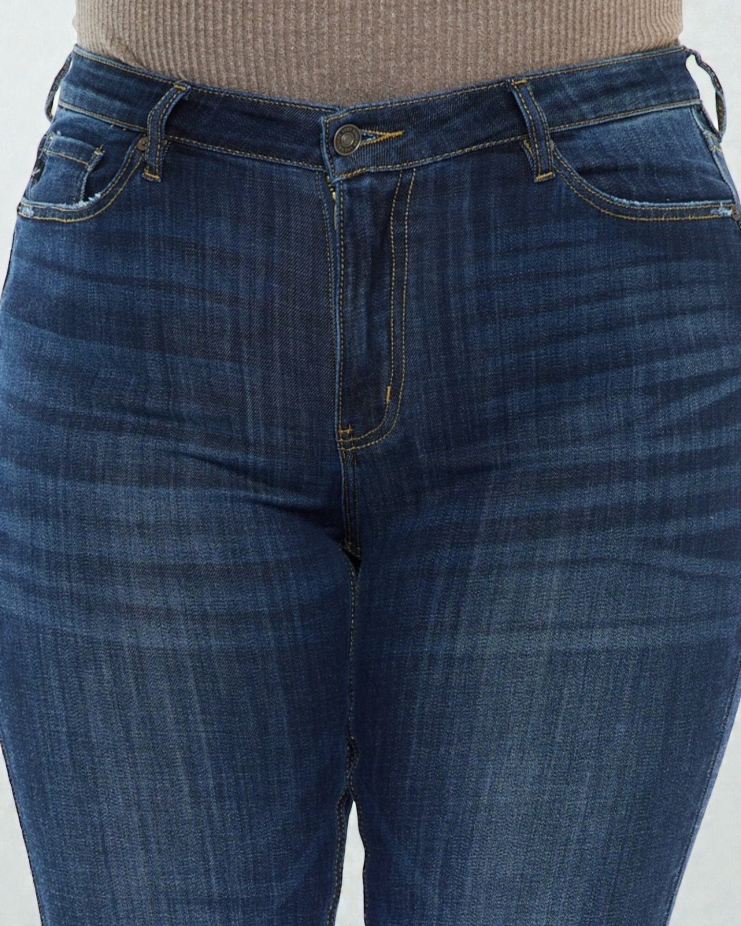 Close-up of blue jeans on a plain background