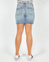 Denim shorts worn by a person on a white background