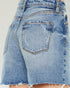 Close-up of a pair of blue denim shorts with a white background