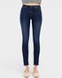 Dark blue jeans worn by a person on a white background
