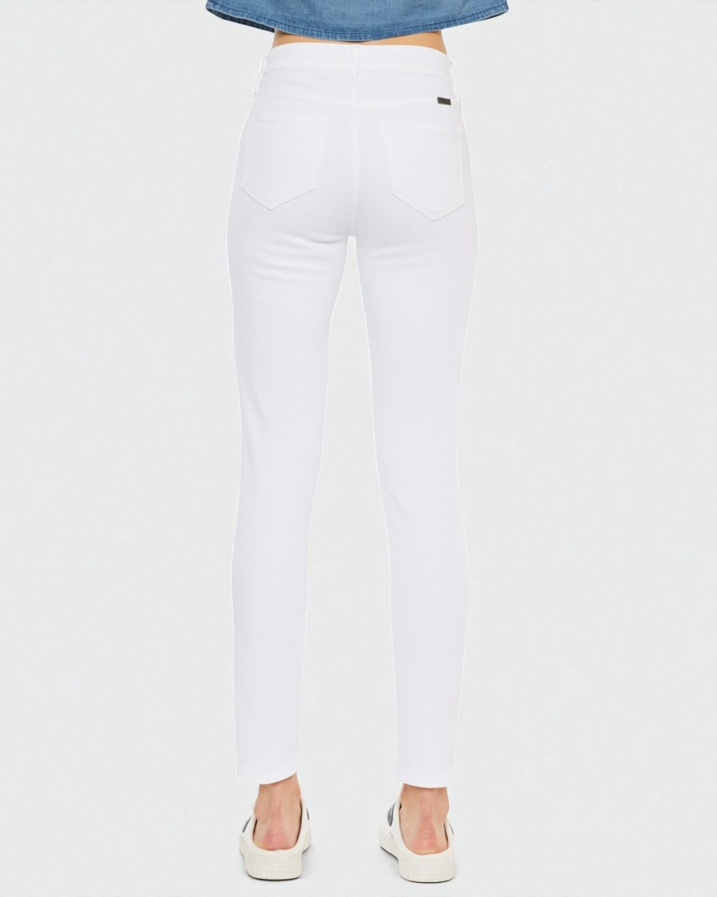 White jeans worn by a person on a white background