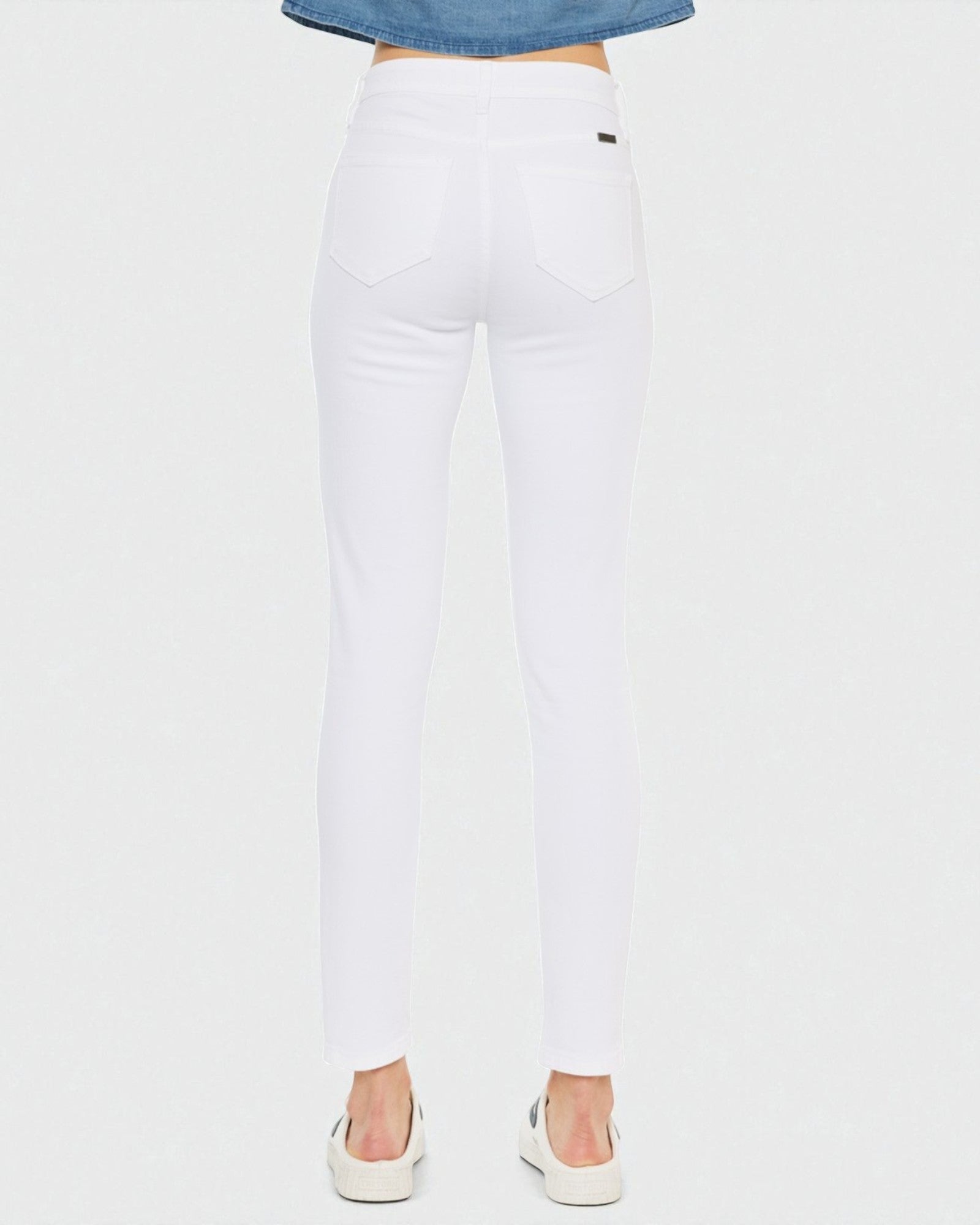 White jeans worn by a person on a white background