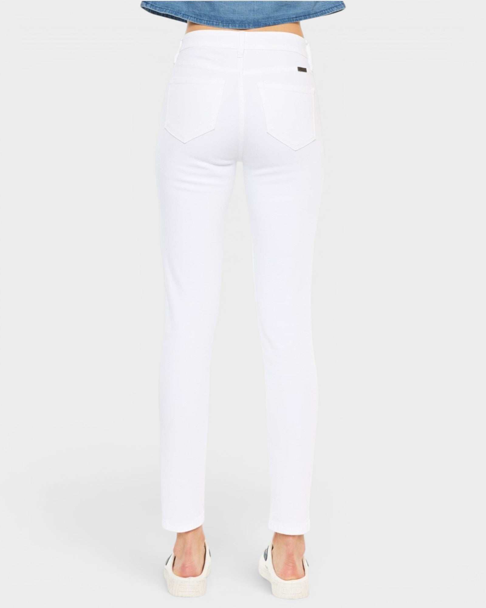 White pants worn by a person on a white background