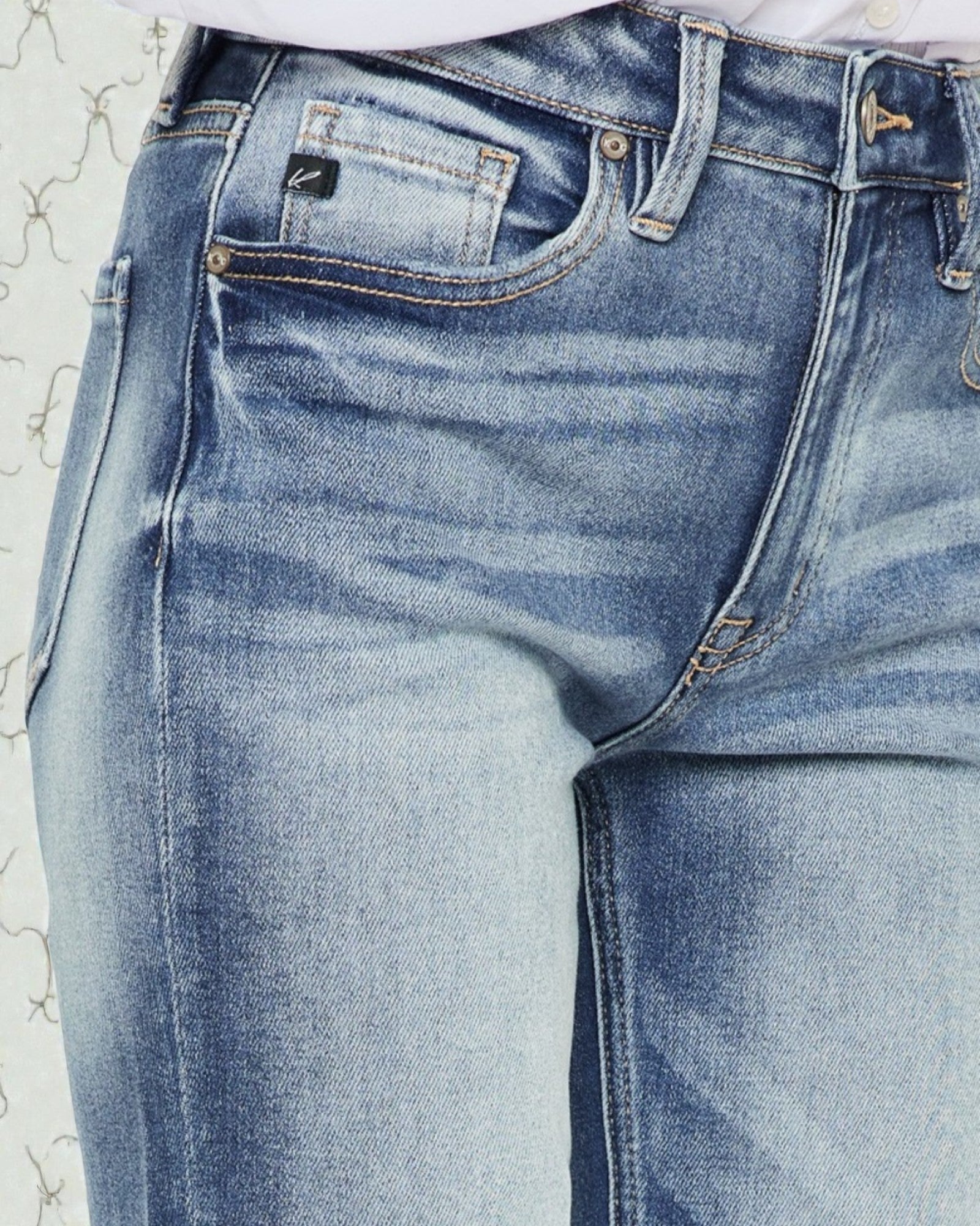 Close-up of blue jeans on a textured white background