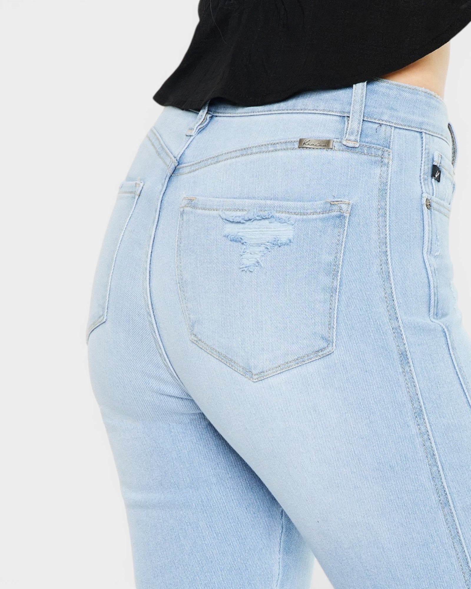Light blue jeans with a visible brand logo on a plain background