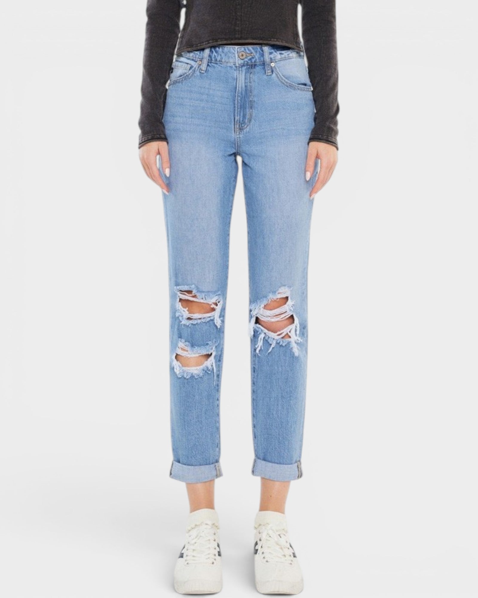Light blue distressed jeans worn by a person on a white background