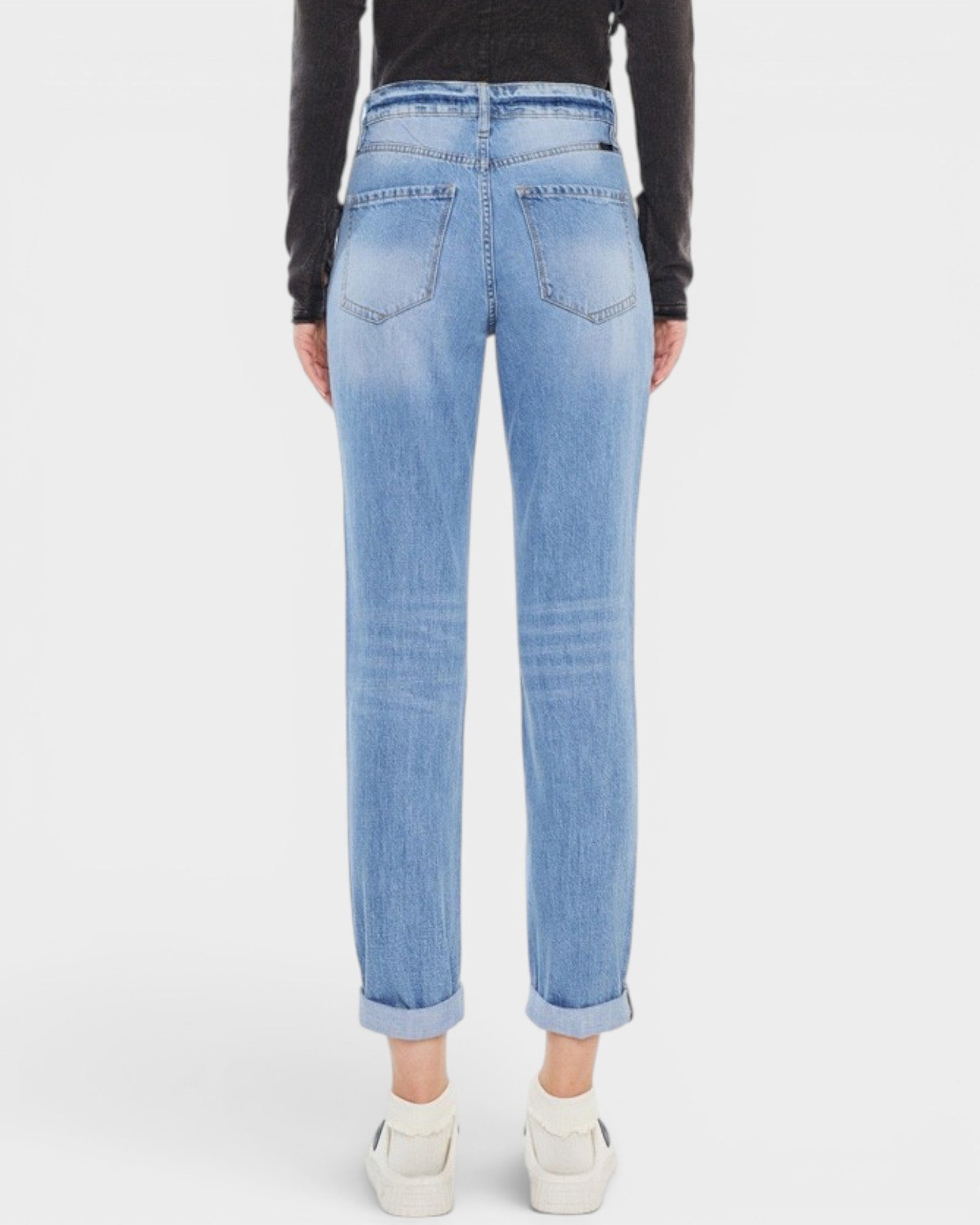 Light blue jeans worn by a person on a white background