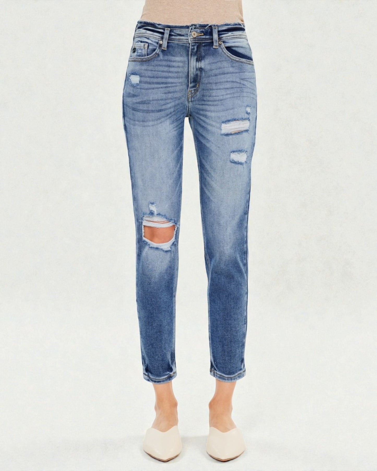 Blue distressed jeans on a white background