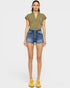 Woman wearing an olive green t-shirt and denim shorts on a white background