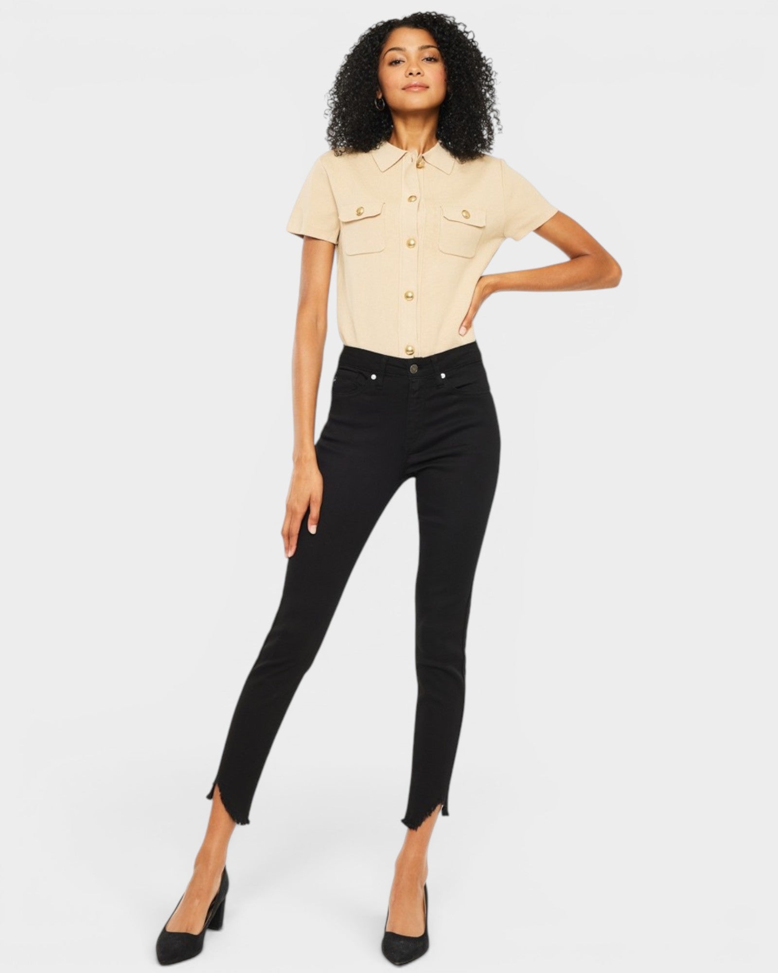 Woman wearing a beige shirt and black pants on a white background