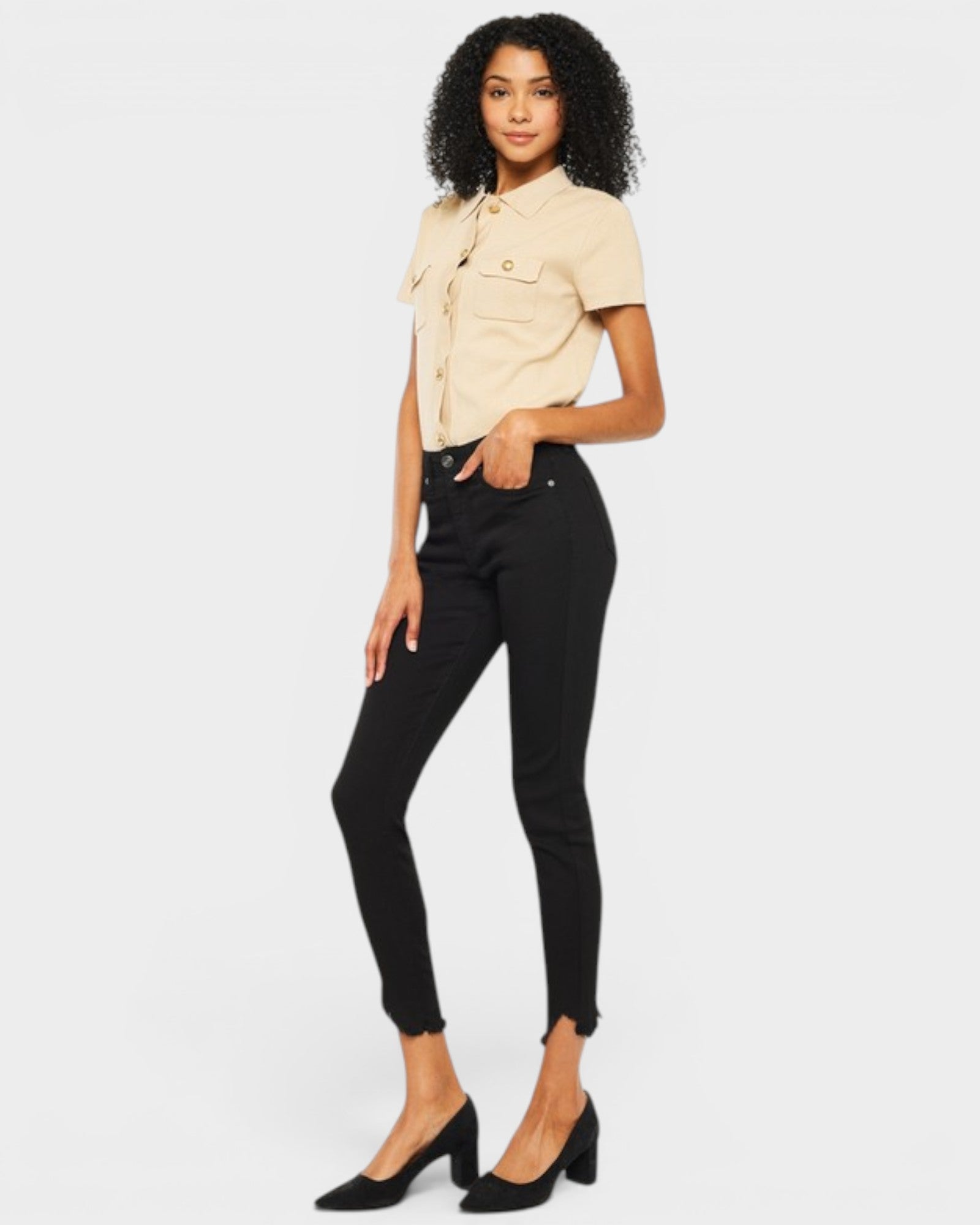 Woman wearing a beige shirt and black pants on a white background