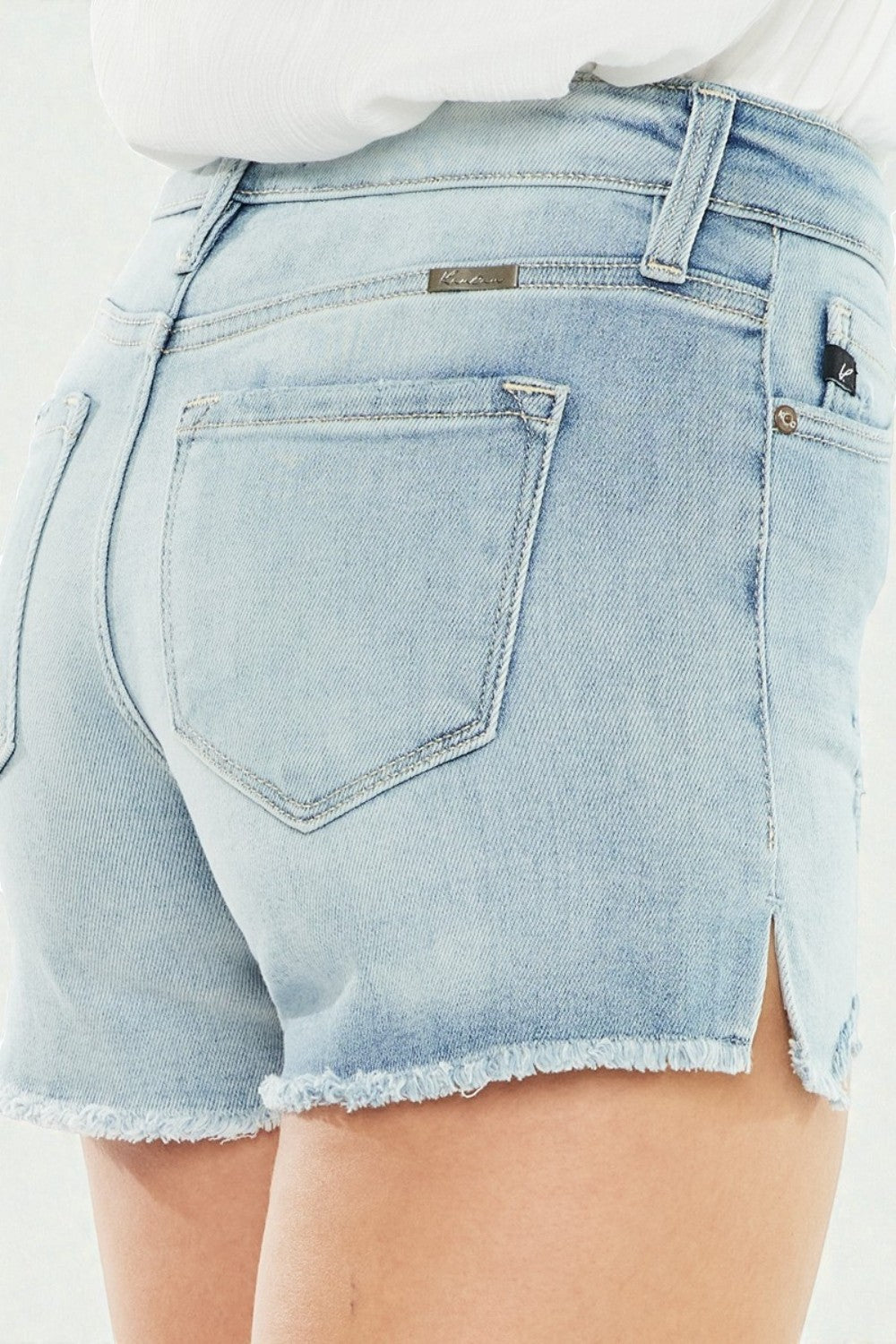 Light blue denim shorts with a brand label on a plain background