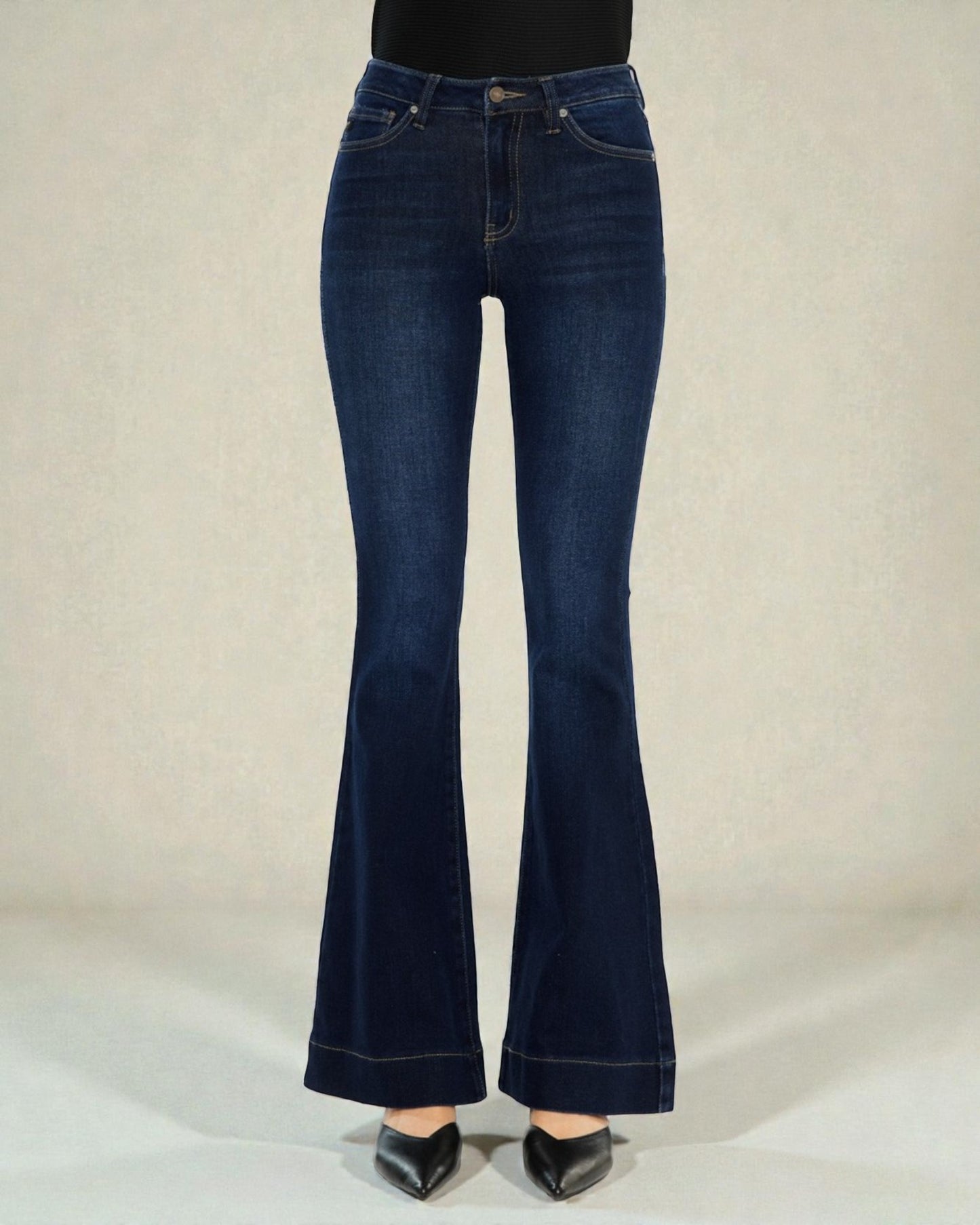 Blue flared jeans on a plain background