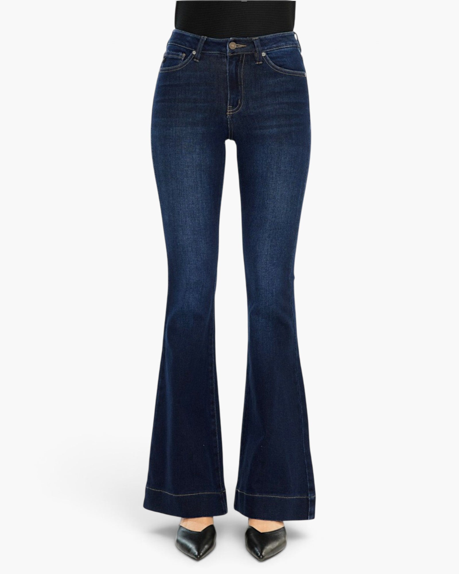 Dark blue high-waisted flare jeans with a subtle whiskering effect, modeled with black pointed-toe heels against a plain white background.