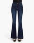 Dark blue high-waisted flare jeans with a subtle whiskering effect, modeled with black pointed-toe heels against a plain white background.