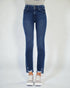 Blue jeans worn by a person on a plain background