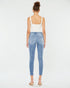 Woman wearing light blue jeans and a white top on a white background
