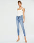 Woman wearing light blue jeans and a white top on a white background