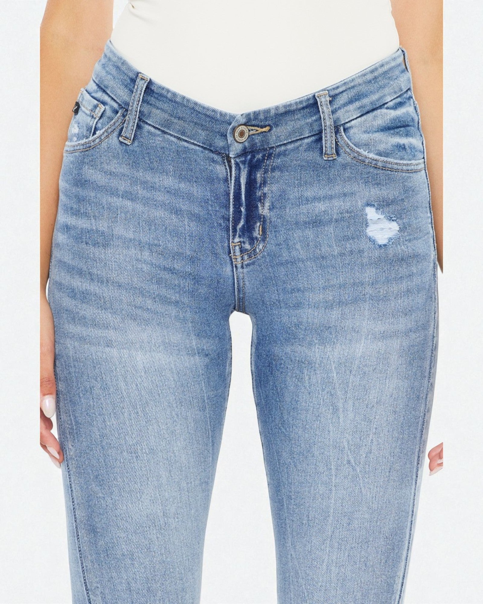 Light blue jeans with a slight distressed effect on a white background