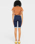 Person wearing a striped shirt and denim shorts on a white background