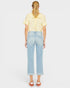 Person wearing a yellow shirt and light blue jeans on a white background