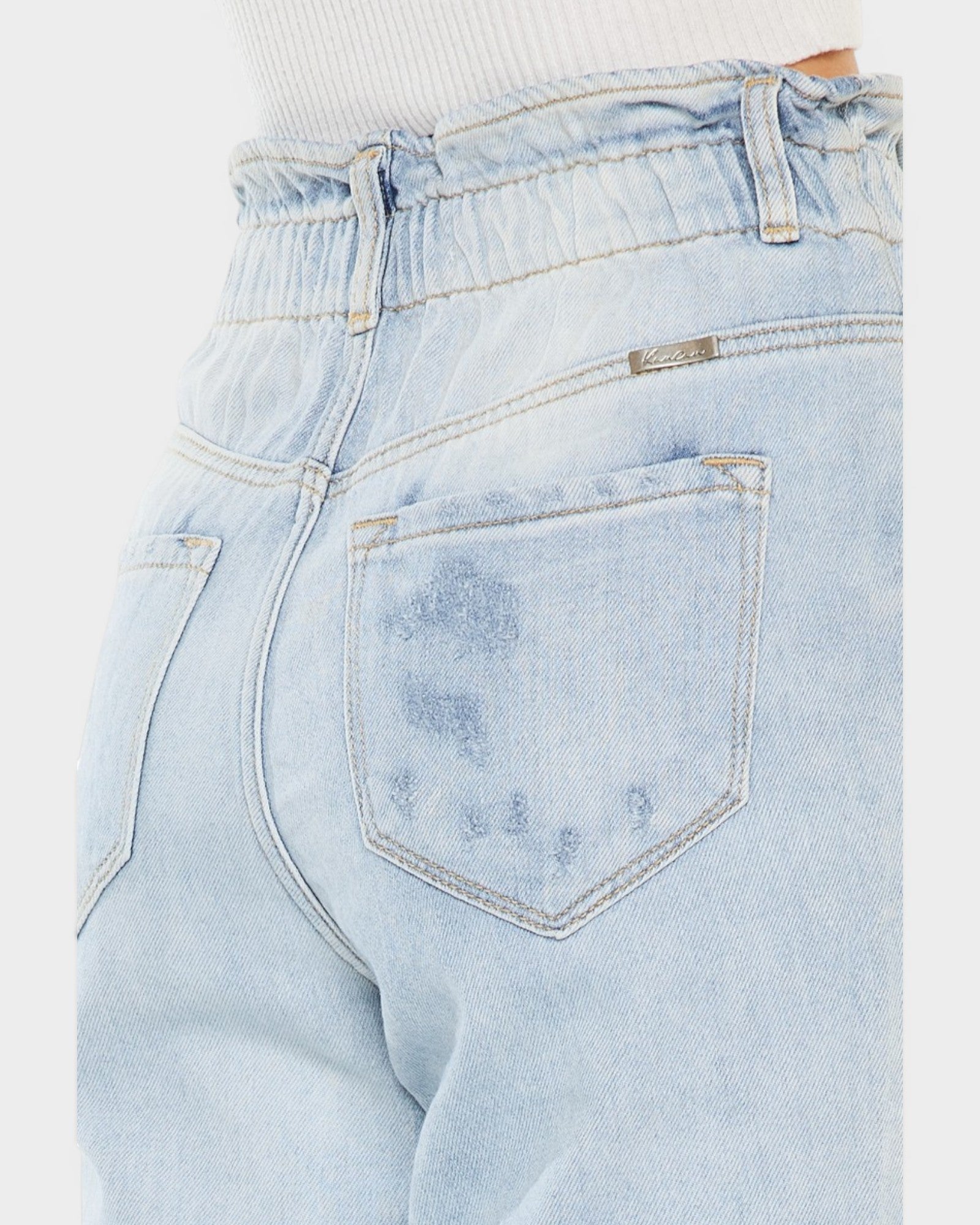 Light blue jeans with a brand label on a white background