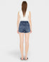 Person wearing blue denim shorts on a white background