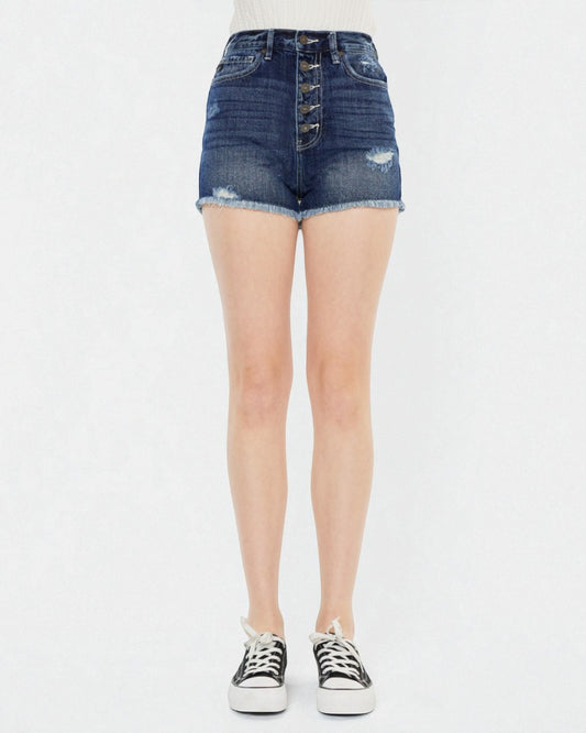 Denim shorts worn by a person on a white background