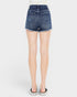 Blue denim shorts worn by a person on a white background